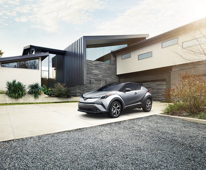 Landscape view of  the 2019 C-HR Limited in Silver Knockout Metallic parked in a family home.