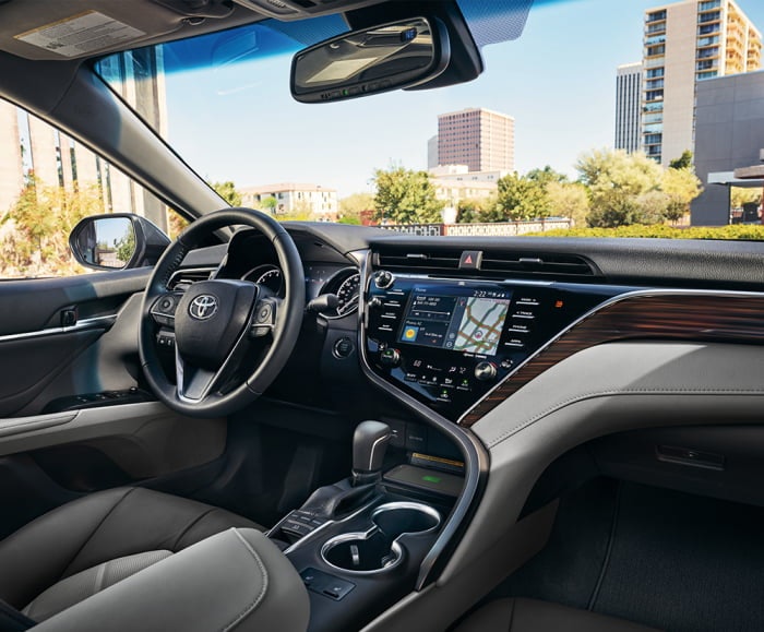 Interior view of steering wheel and IP dash of 2019 Camry in black.