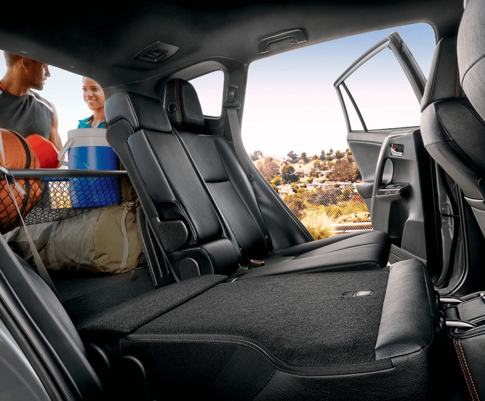 Interior shot of the RAV4 SE's rear seats and cargo space with 60/40 split folding seats and black interior trim.
