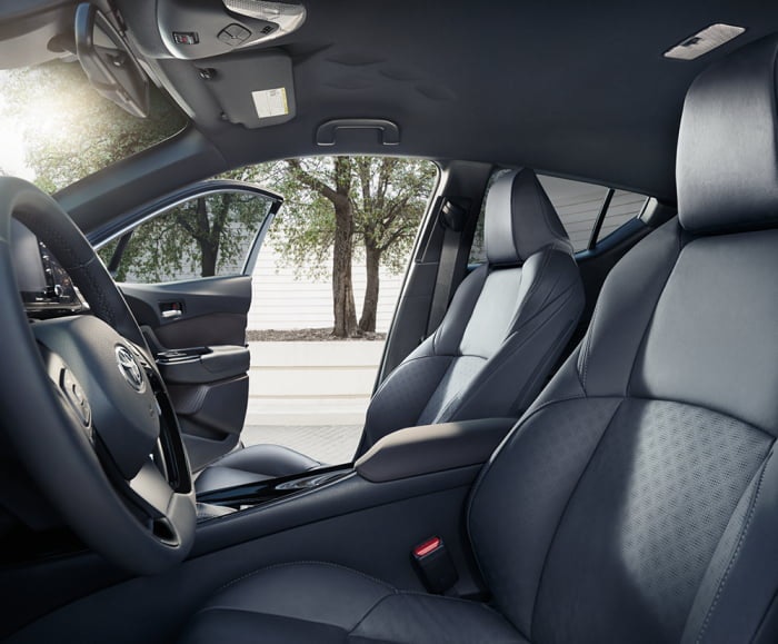 Side-facing view of the driver and passenger seats of the 2019 C-HR Limited with black interior fabric. 