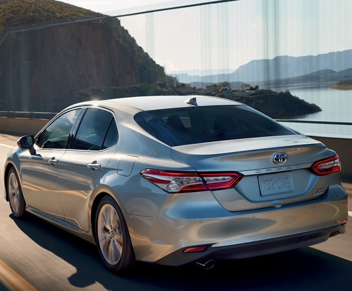 Rear-action shot of the 2019 Hybrid XLE shown in Celestial Silver Metallic with available Driver Assist Package.