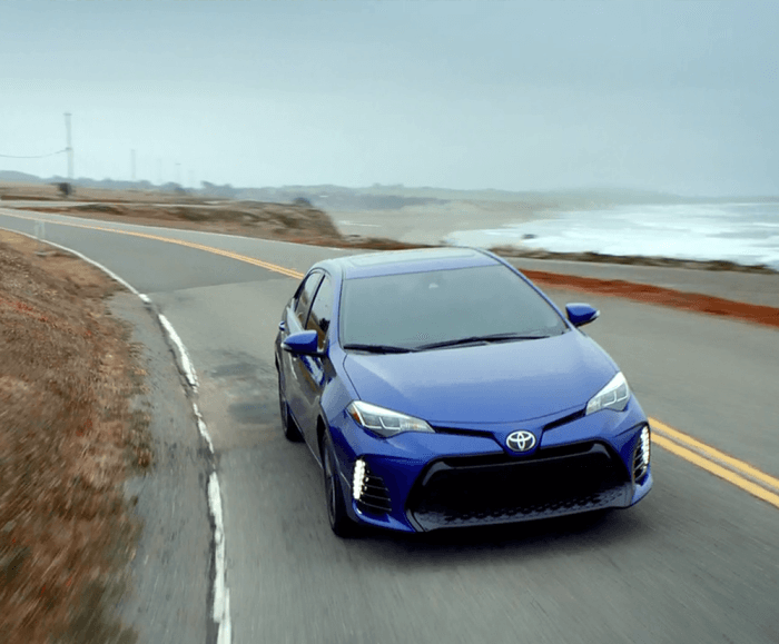 Front-angled shot of the 2017 Toyota Corolla XSE driving along a curved coastal road. 